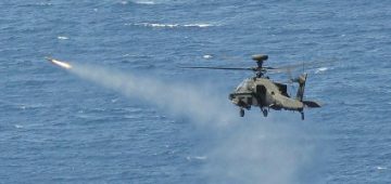 An Army Air Corps Apache attack helicopter launches a Hellfire missile while flying from HMS Ocean. The UK assault carrier is now off Libya. Photo: UK MoD.